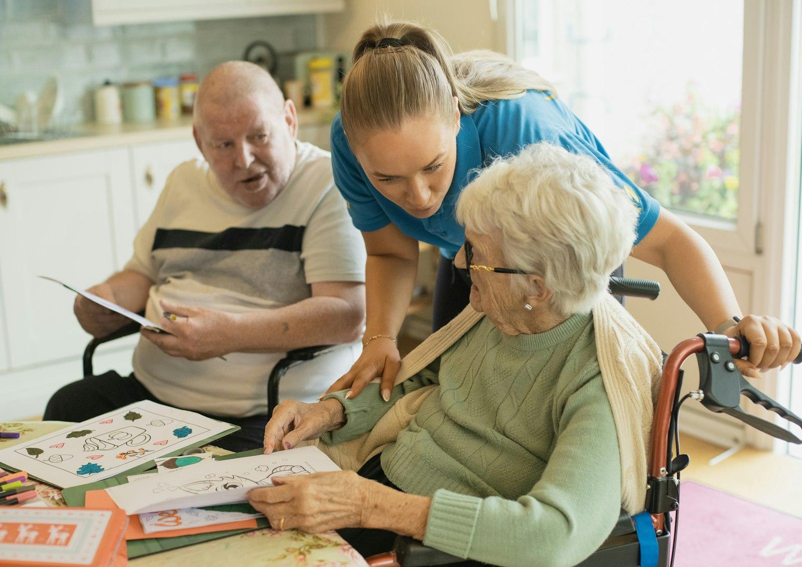 Une préposée accompagne deux résidents lors d'une activité
